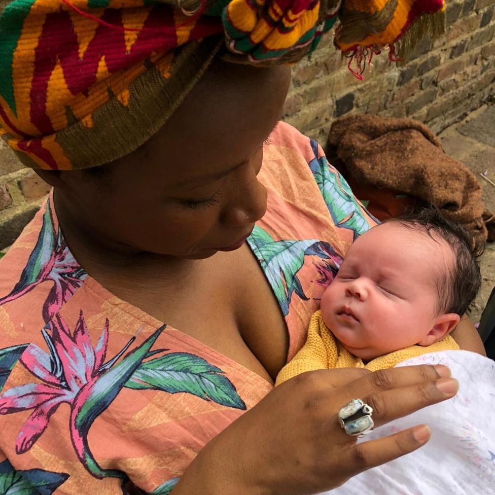 A mother holding her baby, representing the future we build together through partnership.